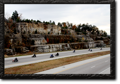 Wide shot of multiple bikers riding down the highway